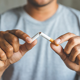 Closeup of patient breaking cigarette