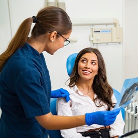 Dentist and patient reviewing X-ray together