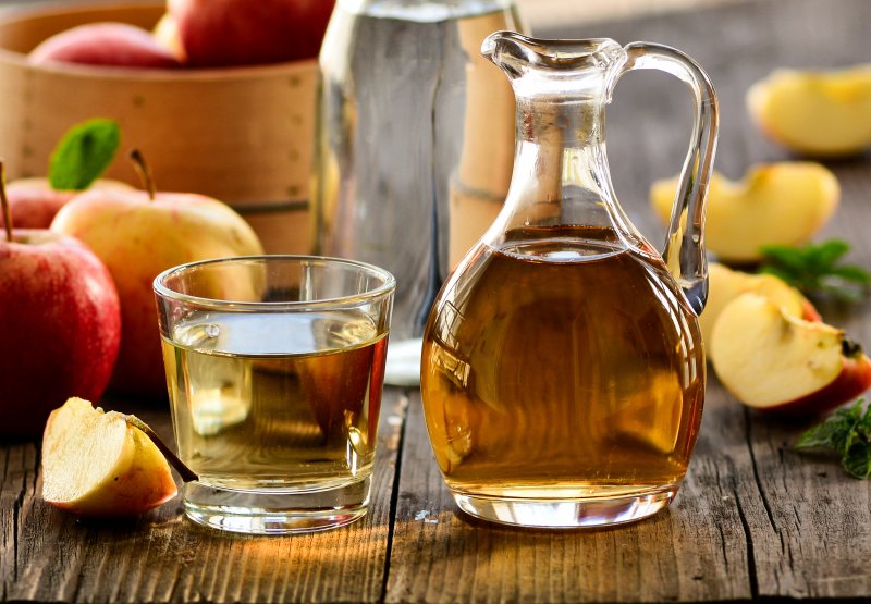 Some apple cider vinegar on a table that affects oral health